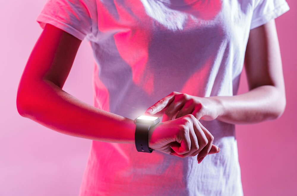 woman looking at smartwatch