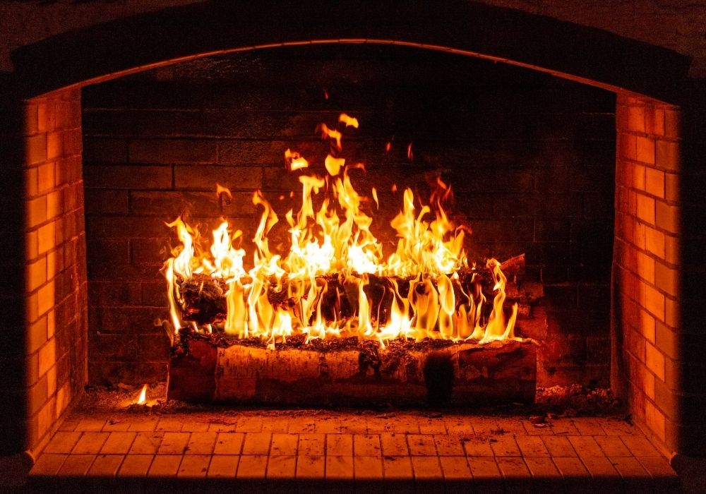 brick fireplace with fire