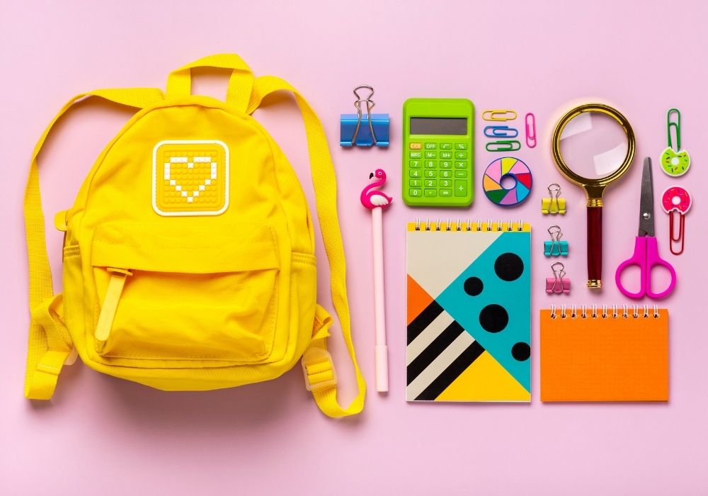 yellow backpack and school supplies
