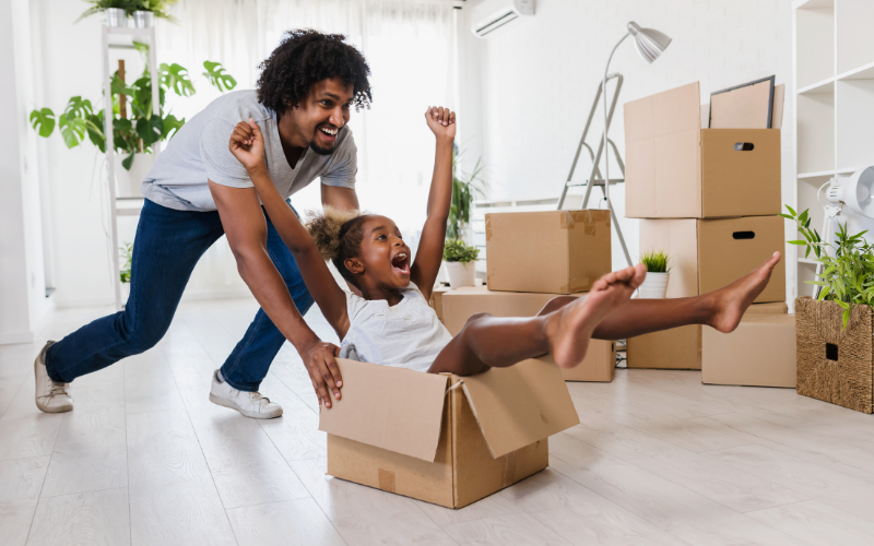 man pushing a girl in an empty cardboard box: Enter key opens full-screen view with caption; escape key exits full screen.
