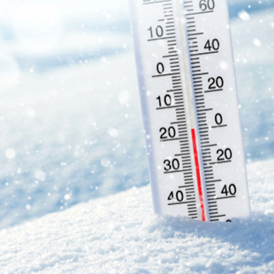A vertical thermometer in the snow shows a red liquid level reaching -20°C or -4°F