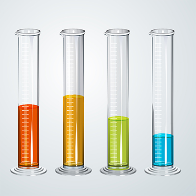 Four glass graduated cylinders containing different levels of red, orange, green, and blue liquids