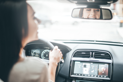 young woman driving a new car