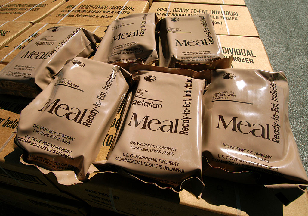 Meals Ready to Eat (MRE's) are displayed on top of a pallet of cases
