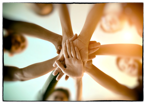 hands stacked on top one another