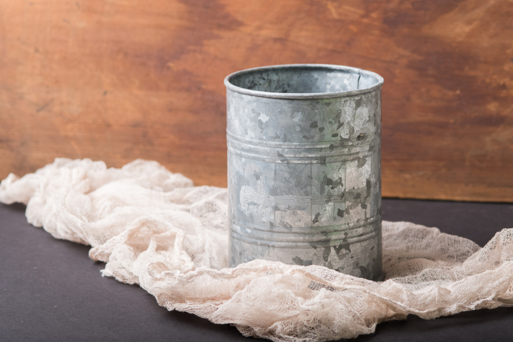Old metal tin can sitting in rustic background