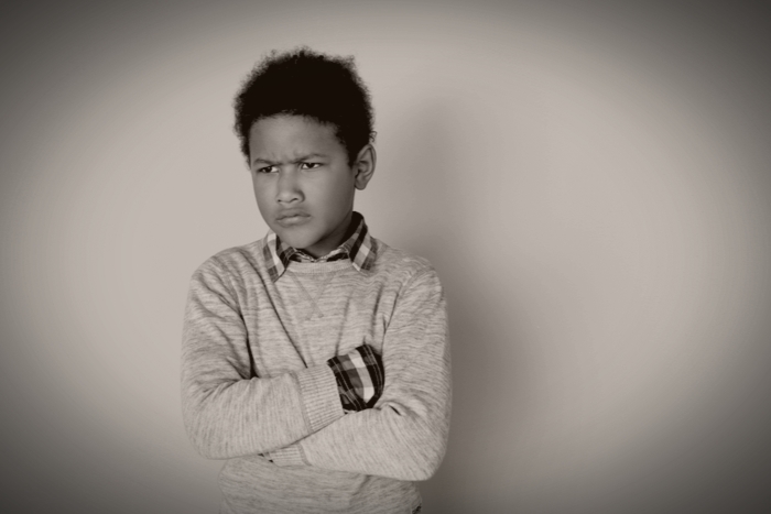 One boy studio isolated looking aside moody 