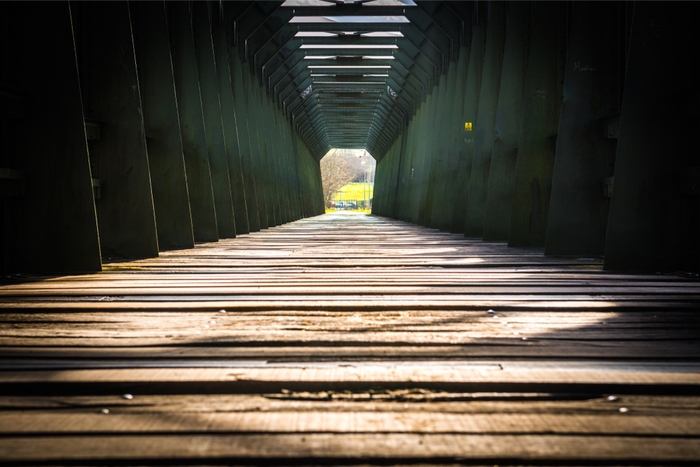 old wooden bridge connecting two roads