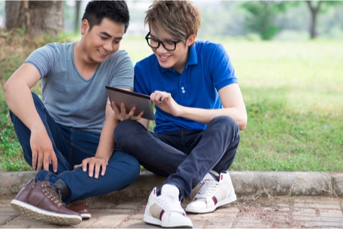 two young men looking at a tablet