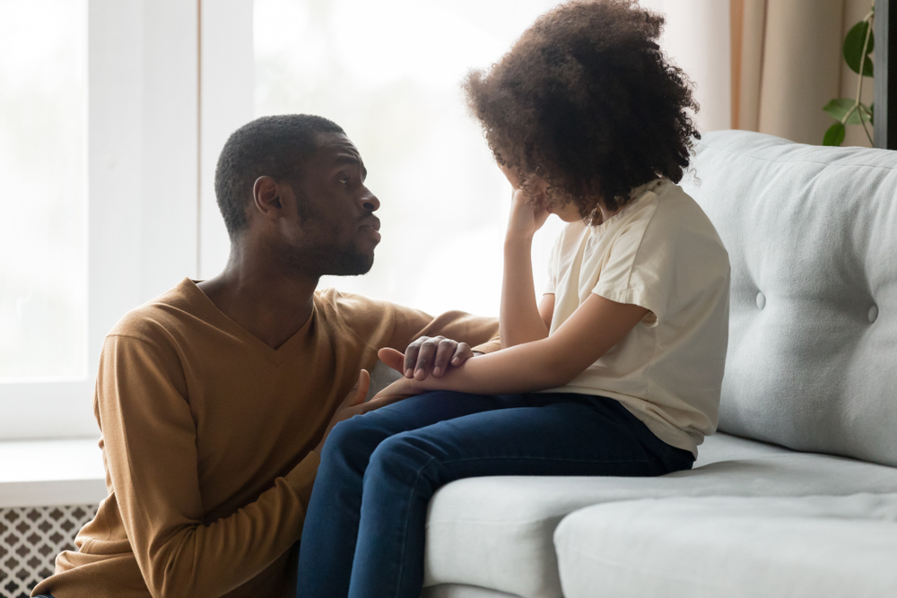 father talkingt to his upset daughter