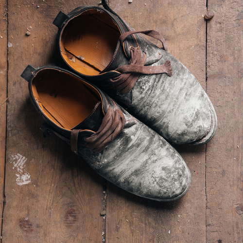 Old shoes on a wooden background