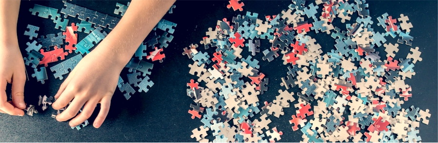 child putting a puzzle together