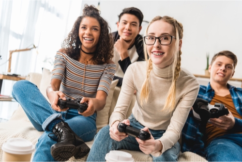 group of teenage friends playing video games