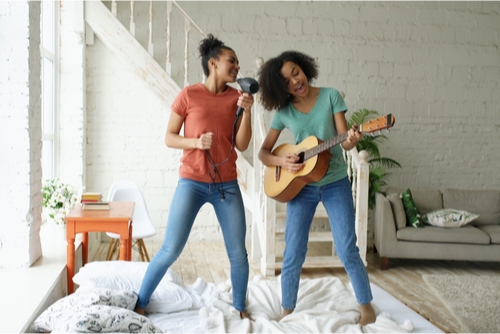 two young ladies singing in their living room