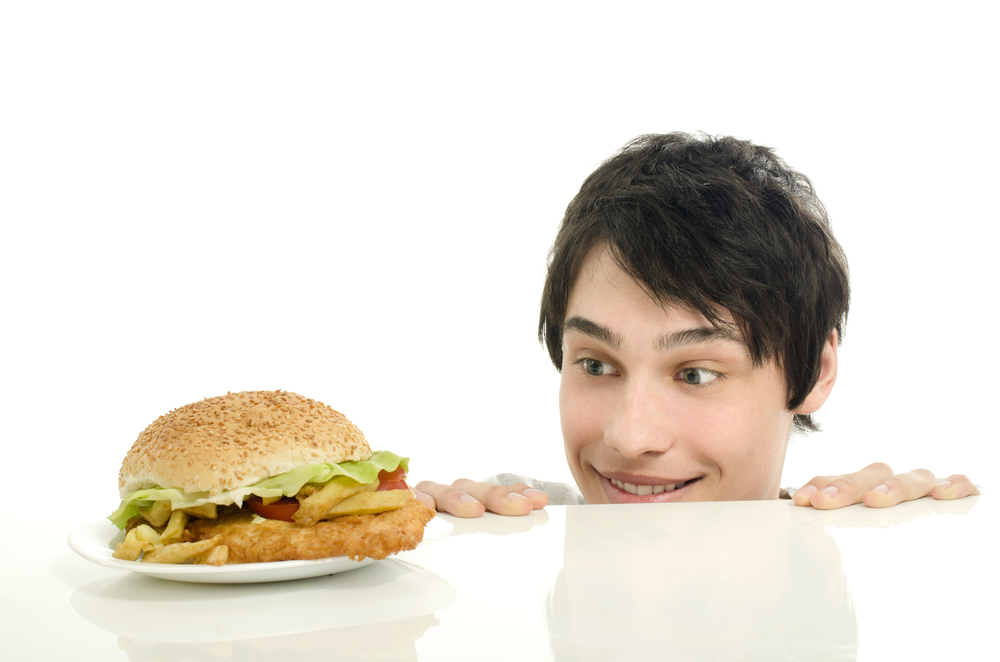 man looking at burger