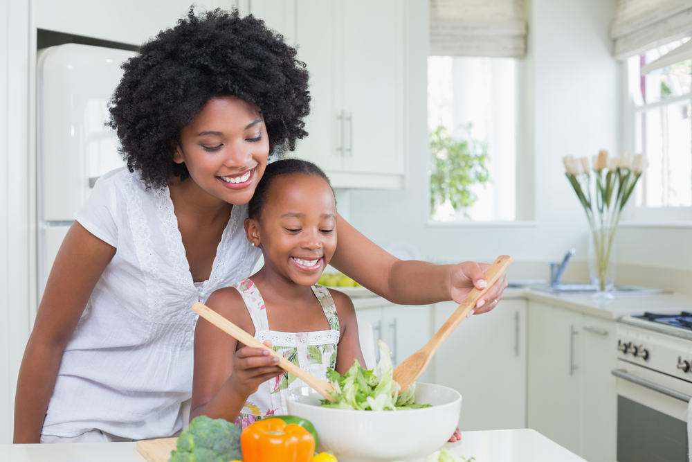mother and daughter making salad