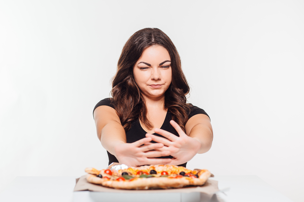 woman refusing pizza