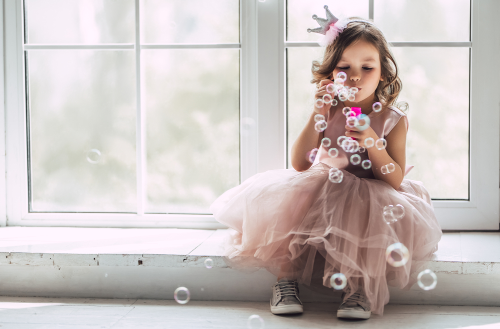 little girl blowing bubbles