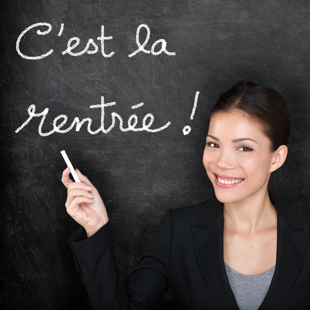 teacher writing on chalkboard C'est la rentrée