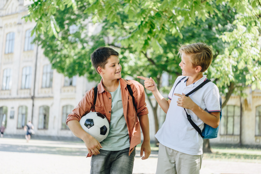 two boys one holding a football