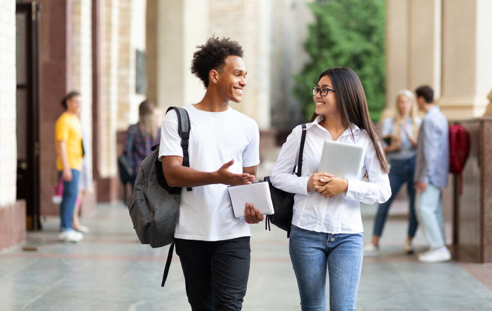 boy and girl walking with school books
