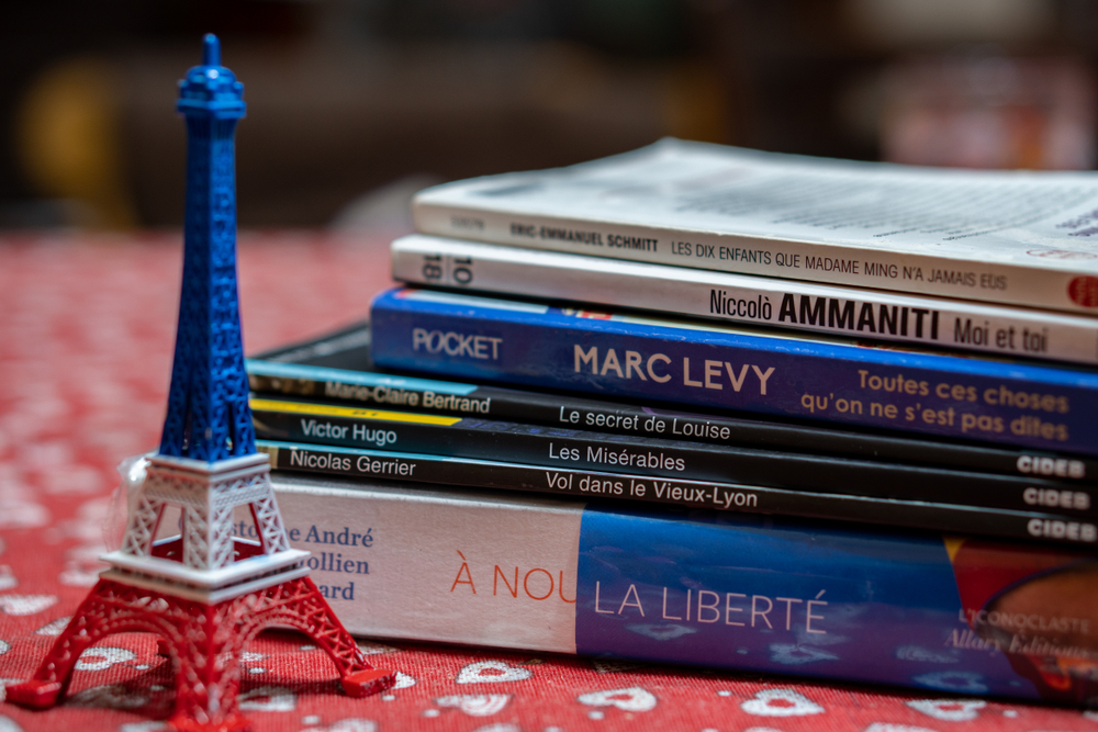 french text books with a small model of the eiffel tower