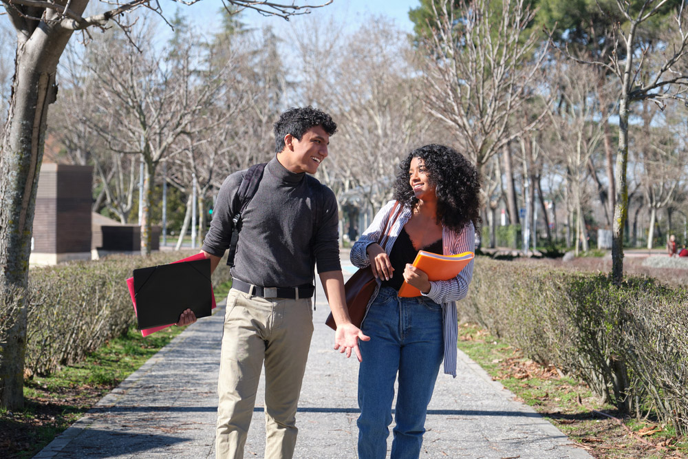 man walking with woman carrying books