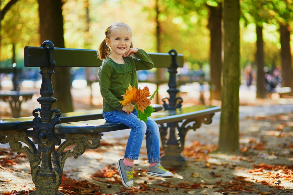 girl sitting on a park bench