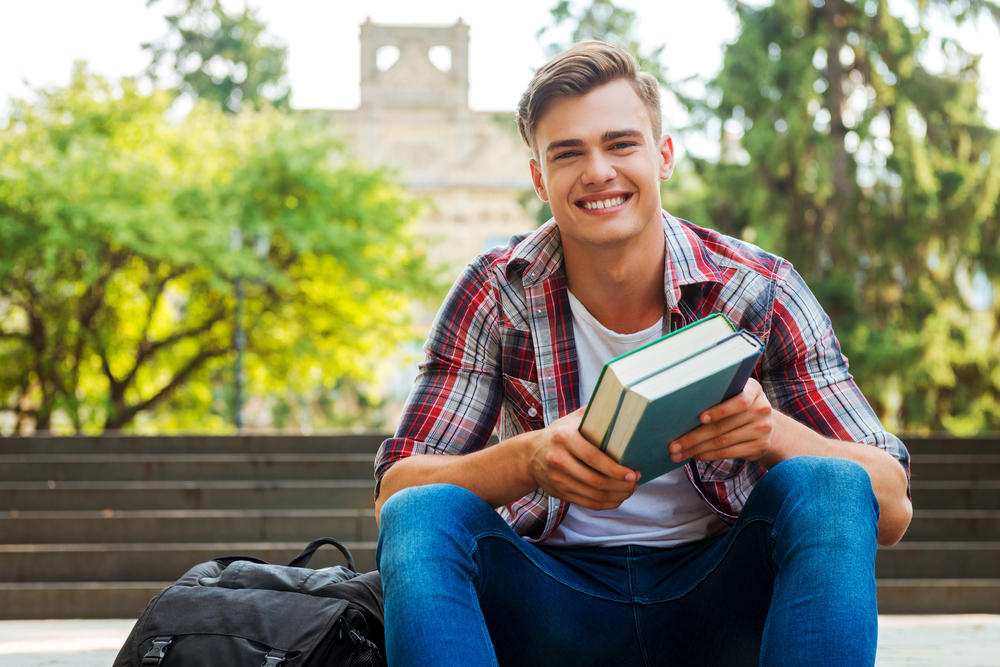 boy student holding school books