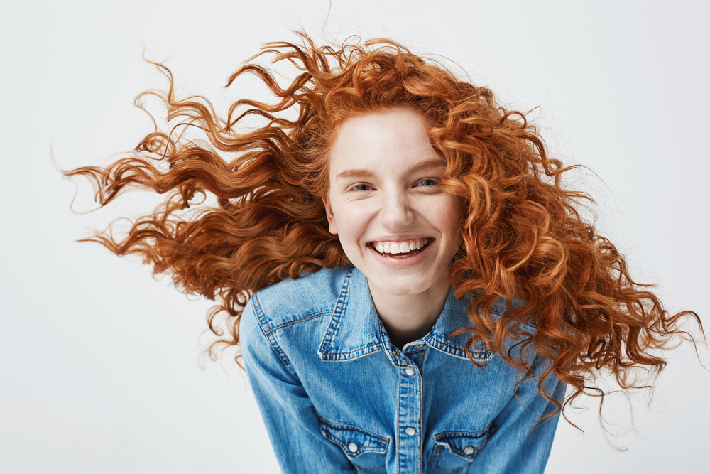girl with red hair smiling