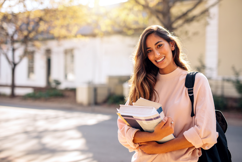 girl holding books