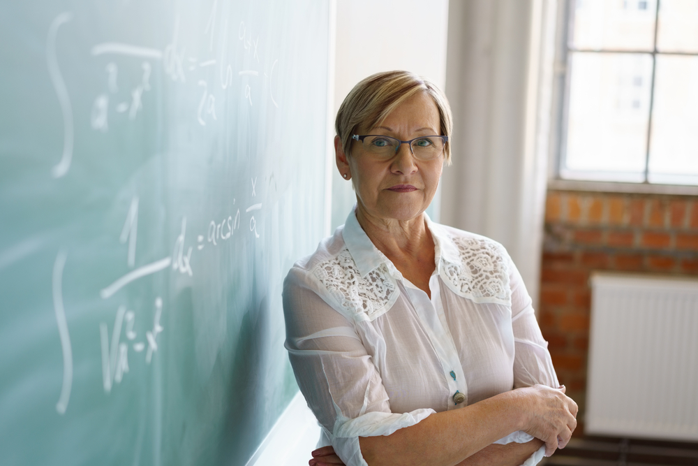 woman teacher in front of chalk board