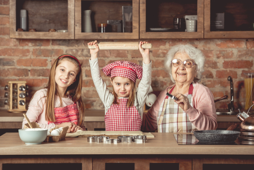 grandmother and two granddaughters cooking