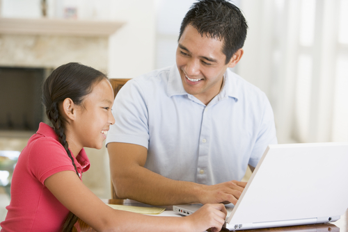 father helping daughter with homework