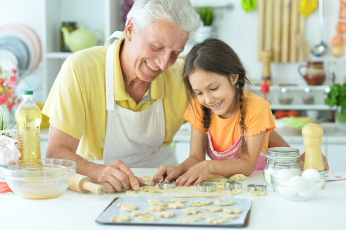 grandfather and granddaughter baking