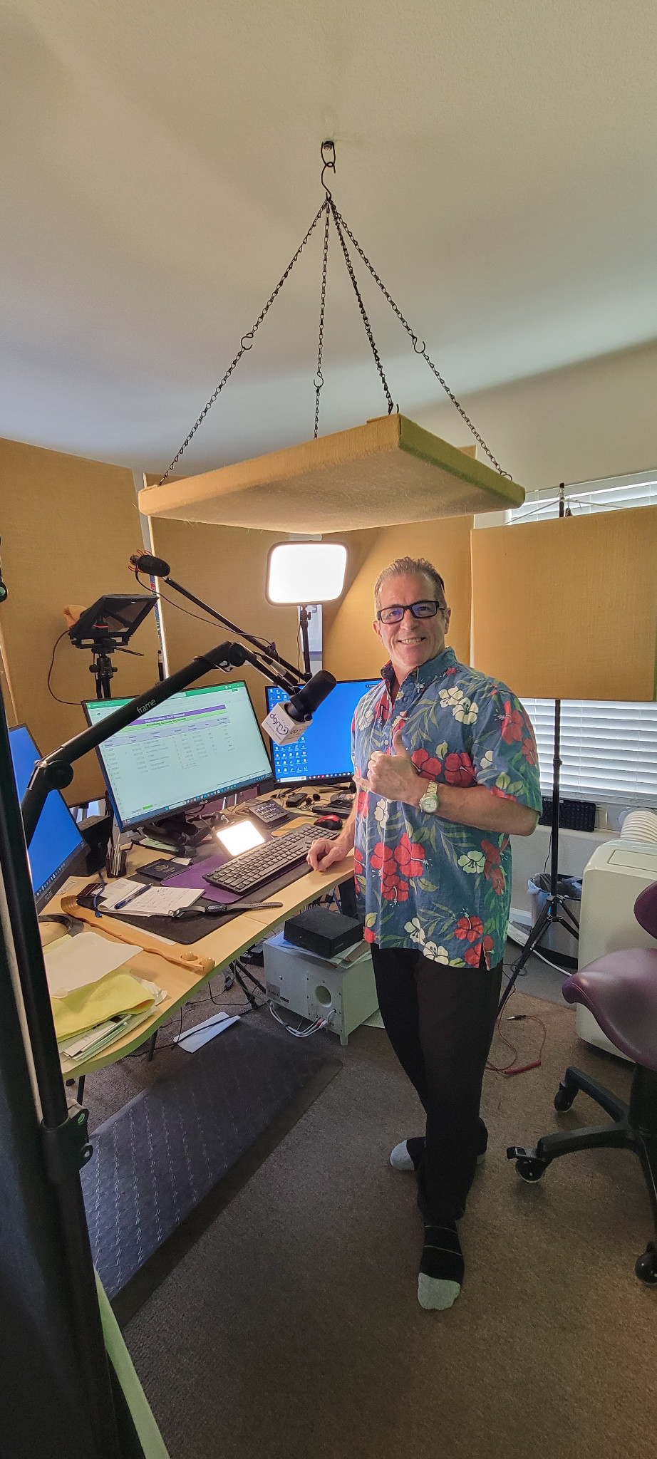 Billy Mr. Aloha in his working studio, with microphones, monitors, lighting and acoustic panels.