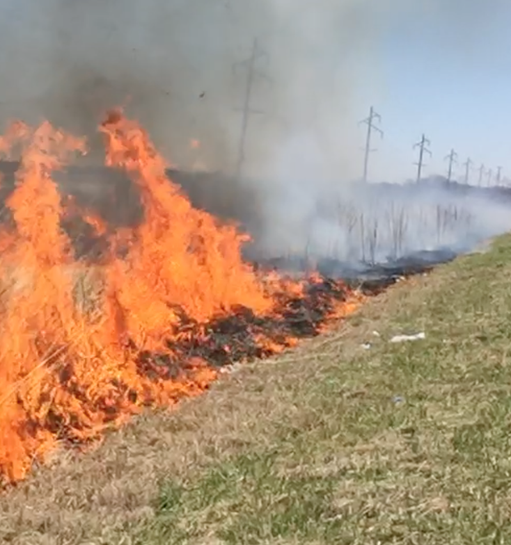 ditch on fire with smoke