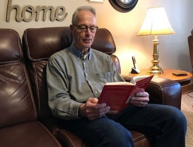 man reading a book with side lighting