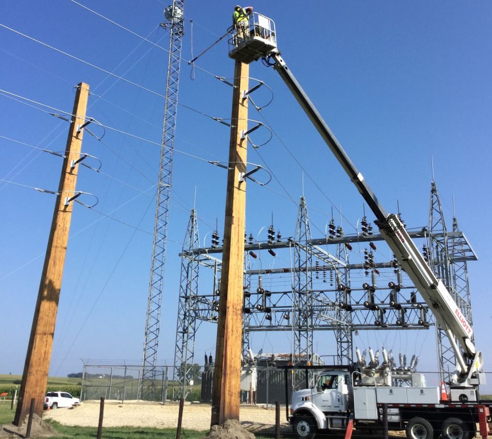 A NIPCO line worker doing work on a shoo-fly high above L2 Substation