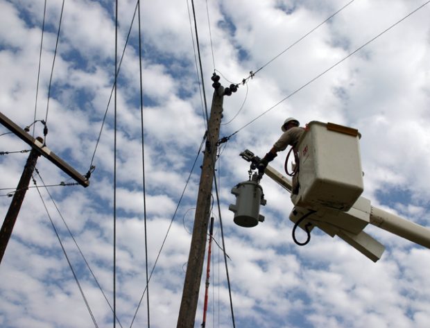 Lineman in a bucket near poles