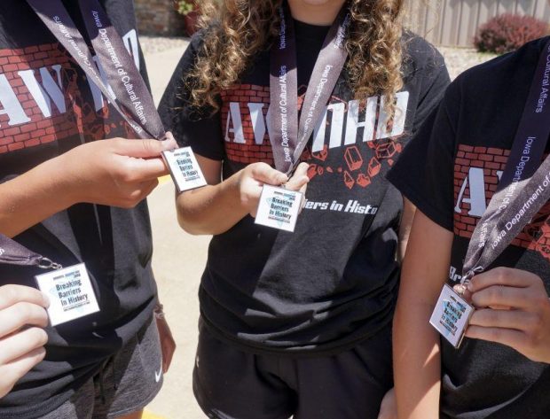 Extreme close-up photo of students holding their medals.