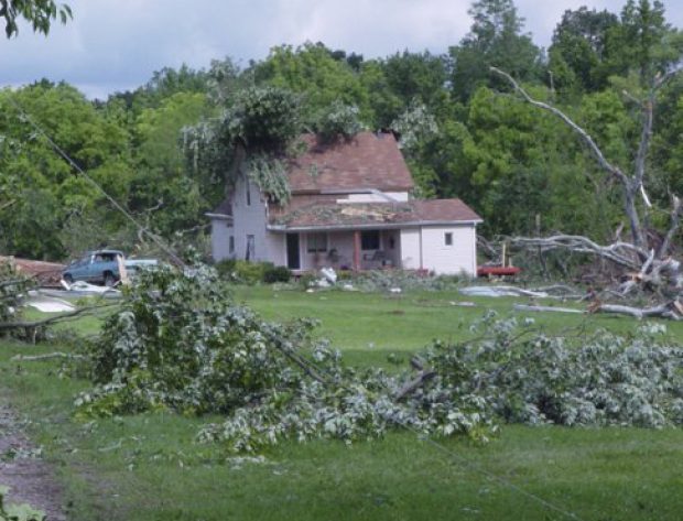 Home after a storm with downed trees and power lines