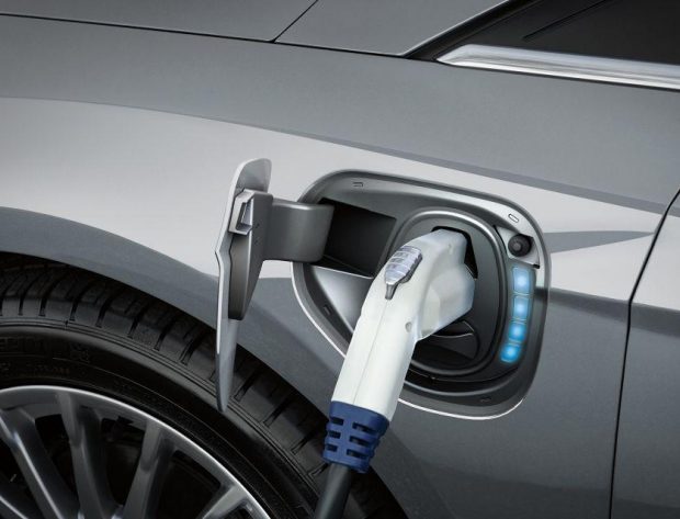 Photo image of an electric vehicle charger plugged into an electric vehicle. Electric vehicles, like the Ford Focus BEV shown here, reduce exhaust emissions. Photo Credit: Ford Motor Company.