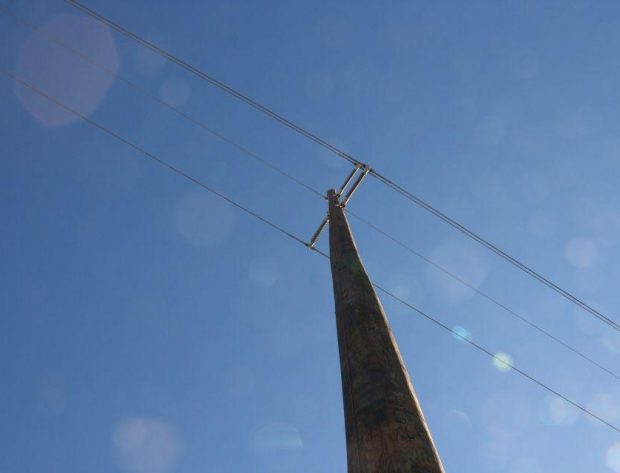 Photo of NIPCO transmission lines with sunrays shining through
