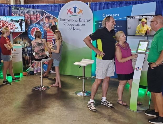 Fairgoers interacting with the state fair exhibit