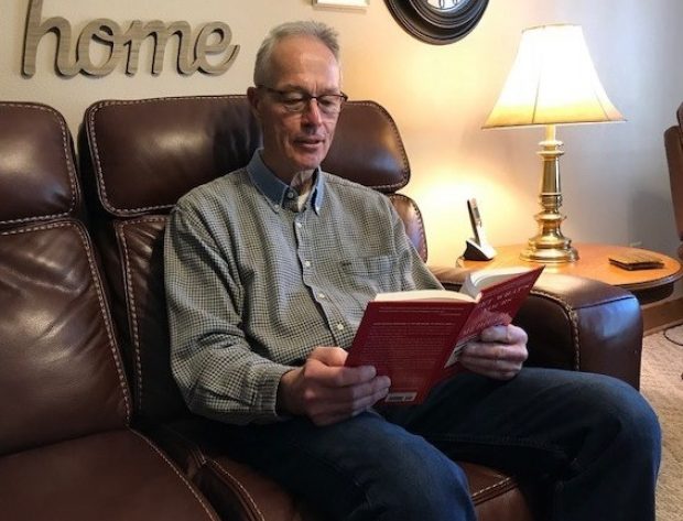 man reading a book with side lighting
