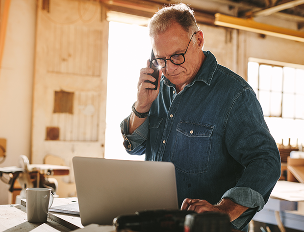 man at computer and phone