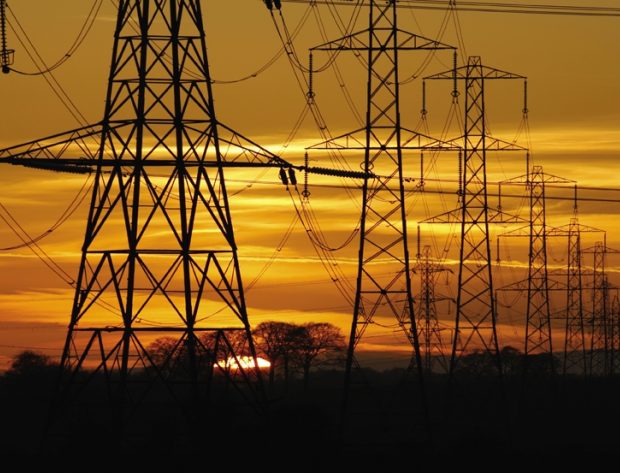 Photo image of high voltage transmission lines at sunset