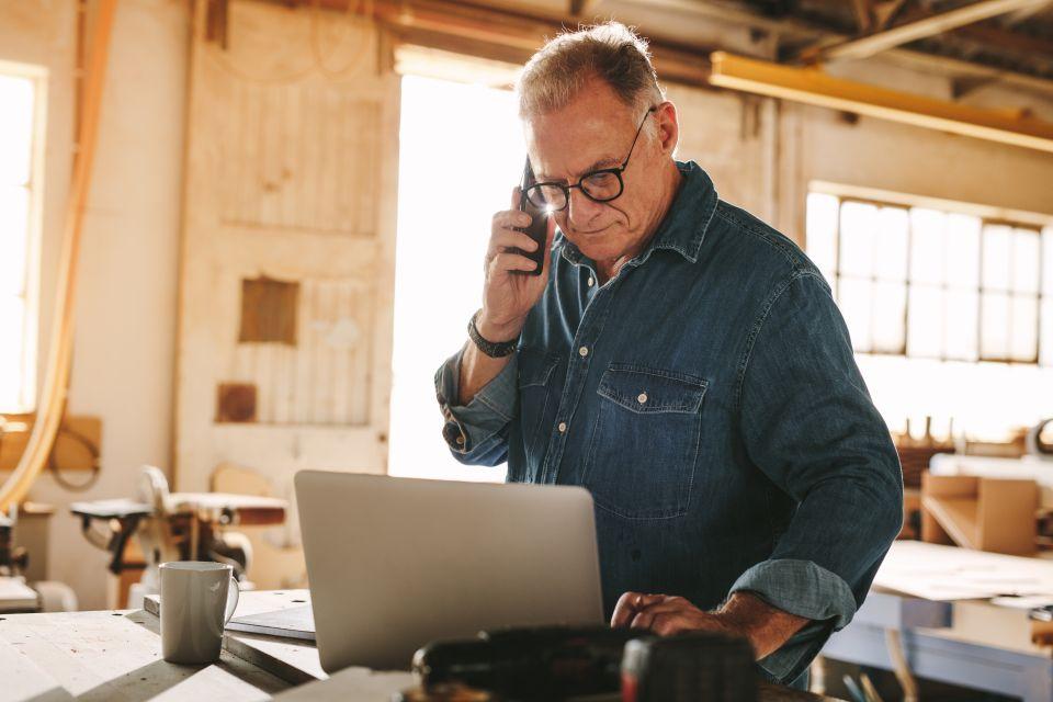 man on phone and computer