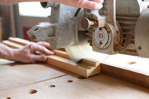 working with a block of wood with a shop tool